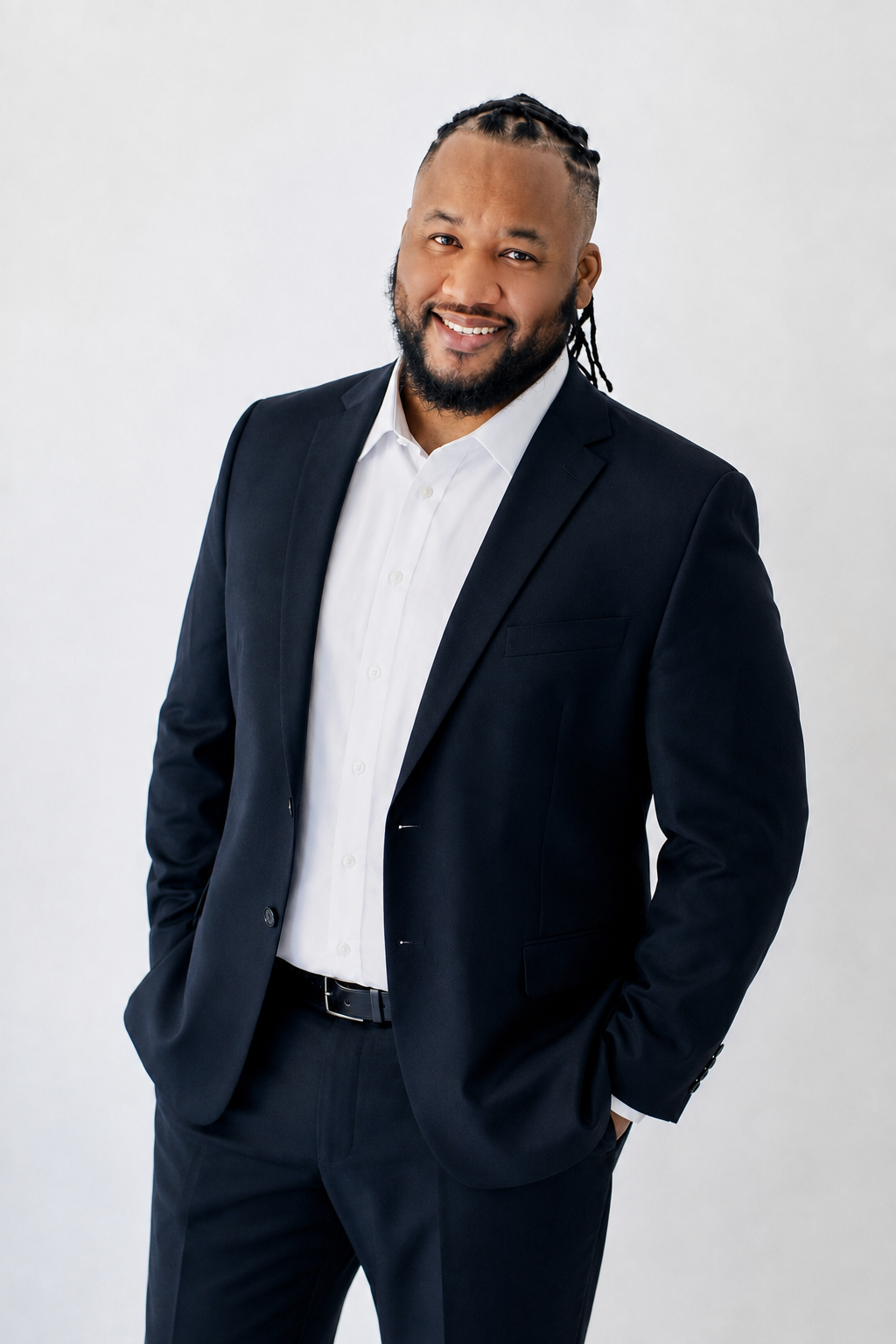 Reggie Washington, founder of Reel Motion Pros, in a dark suit against a light background